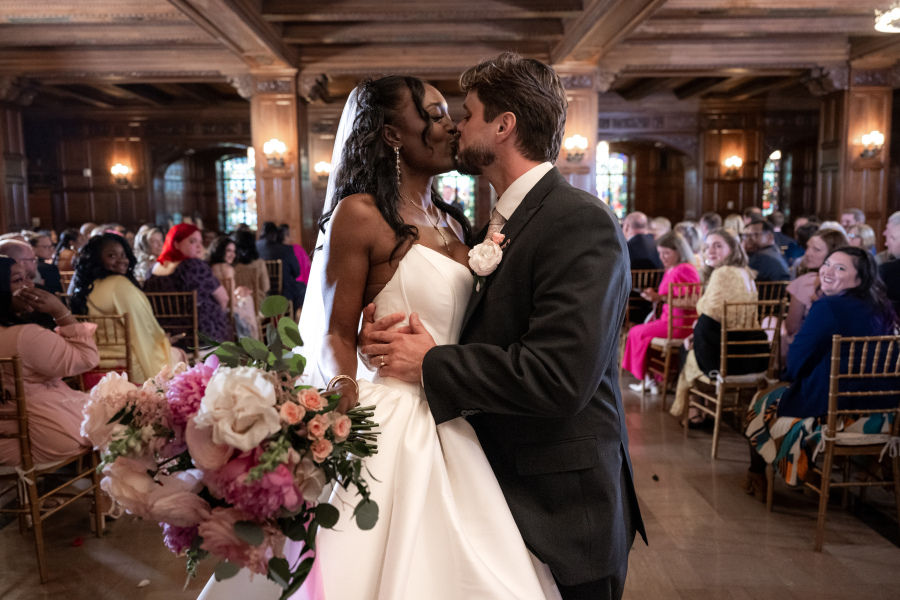 bride and groom kiss after wedding ceremony