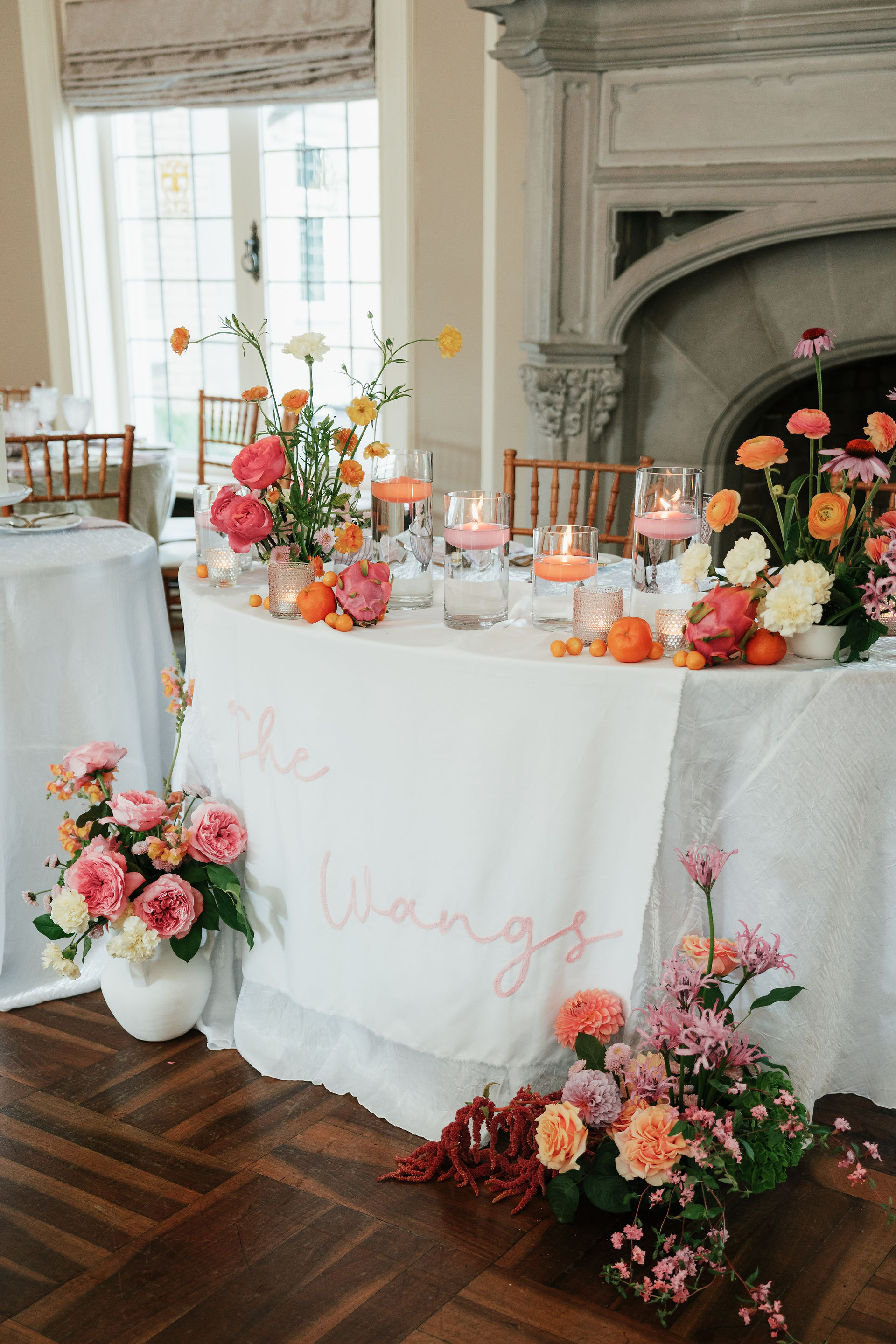 Sweetheart table with colorful flowers and sign with name 