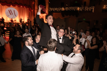 groomsmen lifting groom up on dancefloor. happy mood