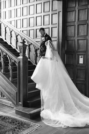 groom leading bride up the stairs