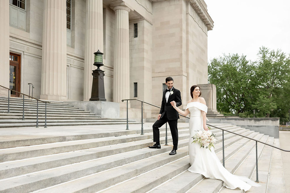 groom looking at bride walking up steps