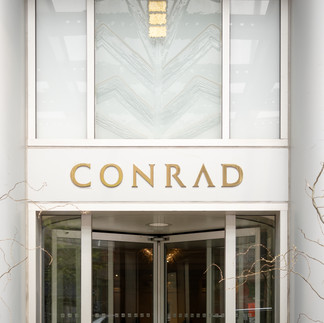 photo of the conrad hotel sign in the front