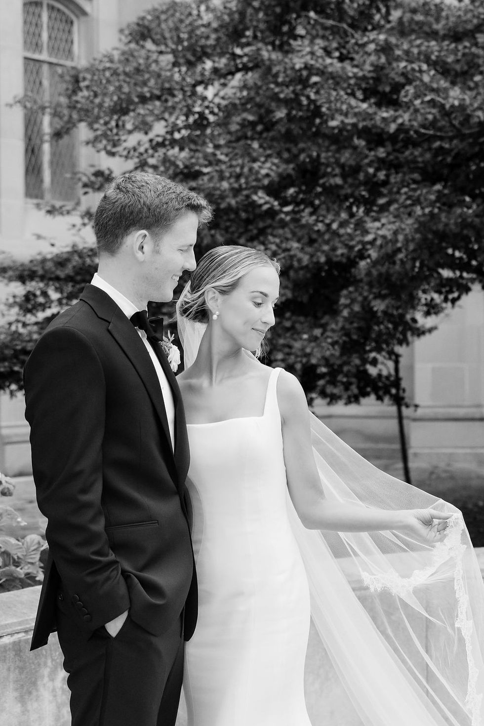 groom smiling at bride looking at her