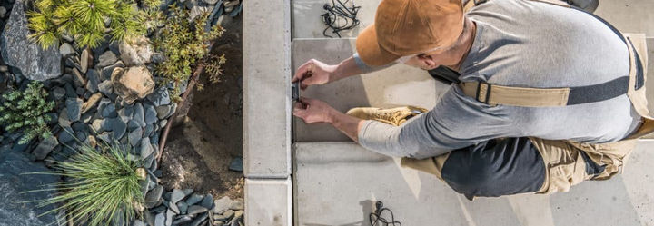 landscaping-worker-installing-garden-concrete-stai.jpeg