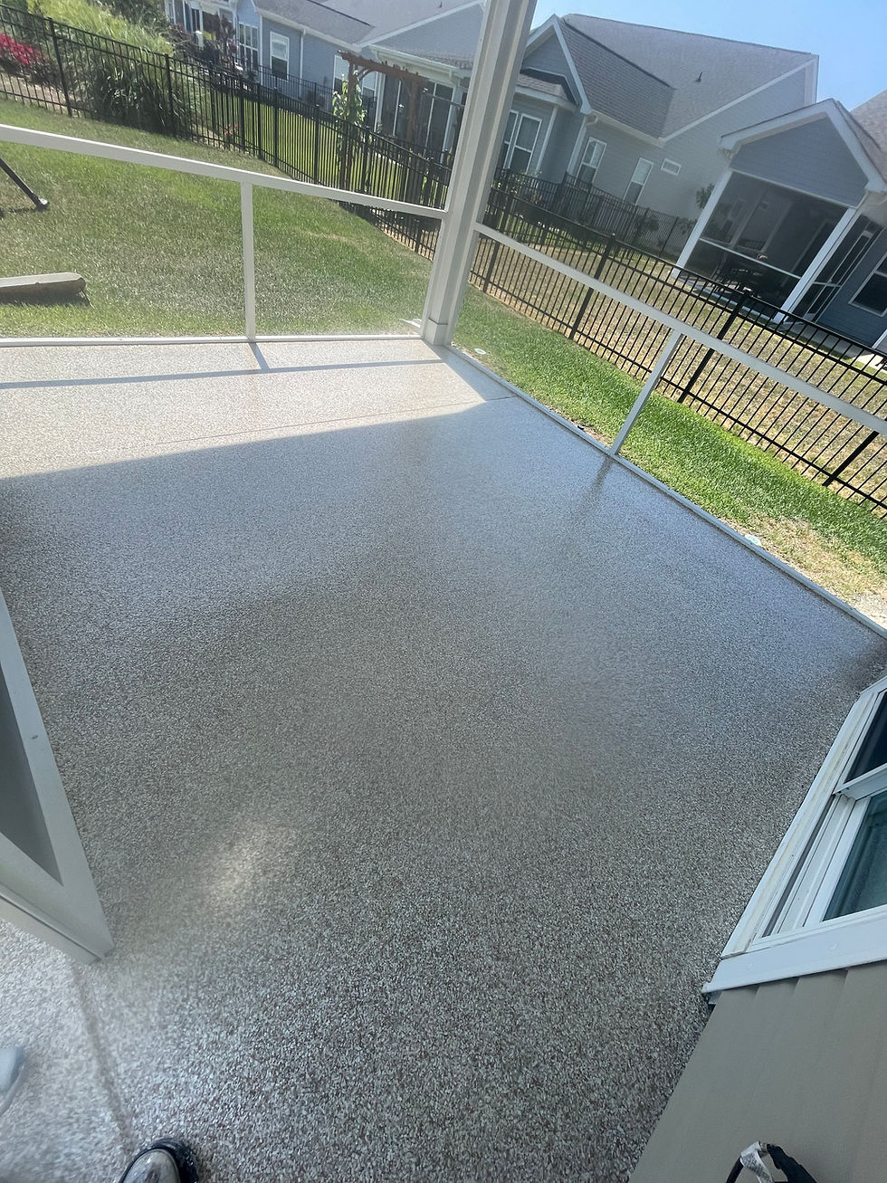 Completed epoxy flooring in screened in patio