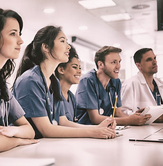 Medical students listening sitting at desk at the university.jpg