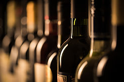 Row of vintage wine bottles in a wine cellar (shallow DOF; color toned image).jpg