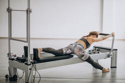 woman-practising-pilates-pilates-reformer