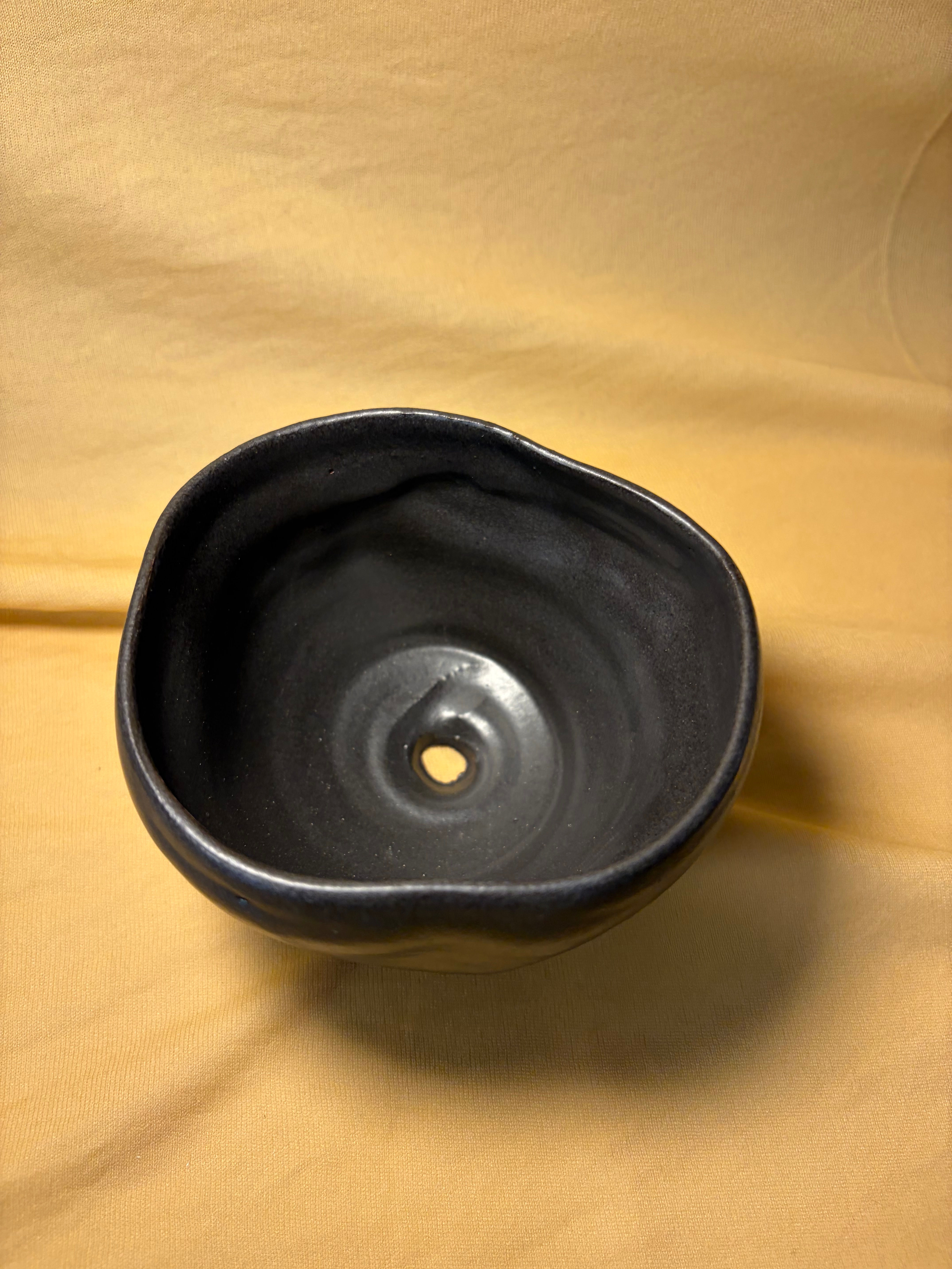 matte black planter with hole at base