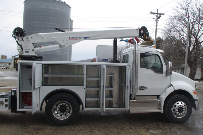 A passenger side view of a white 2026 Kenworth T280 Stellar Industries mechanic service truck with it's service body doors open to showcase tool and equipment shelving.