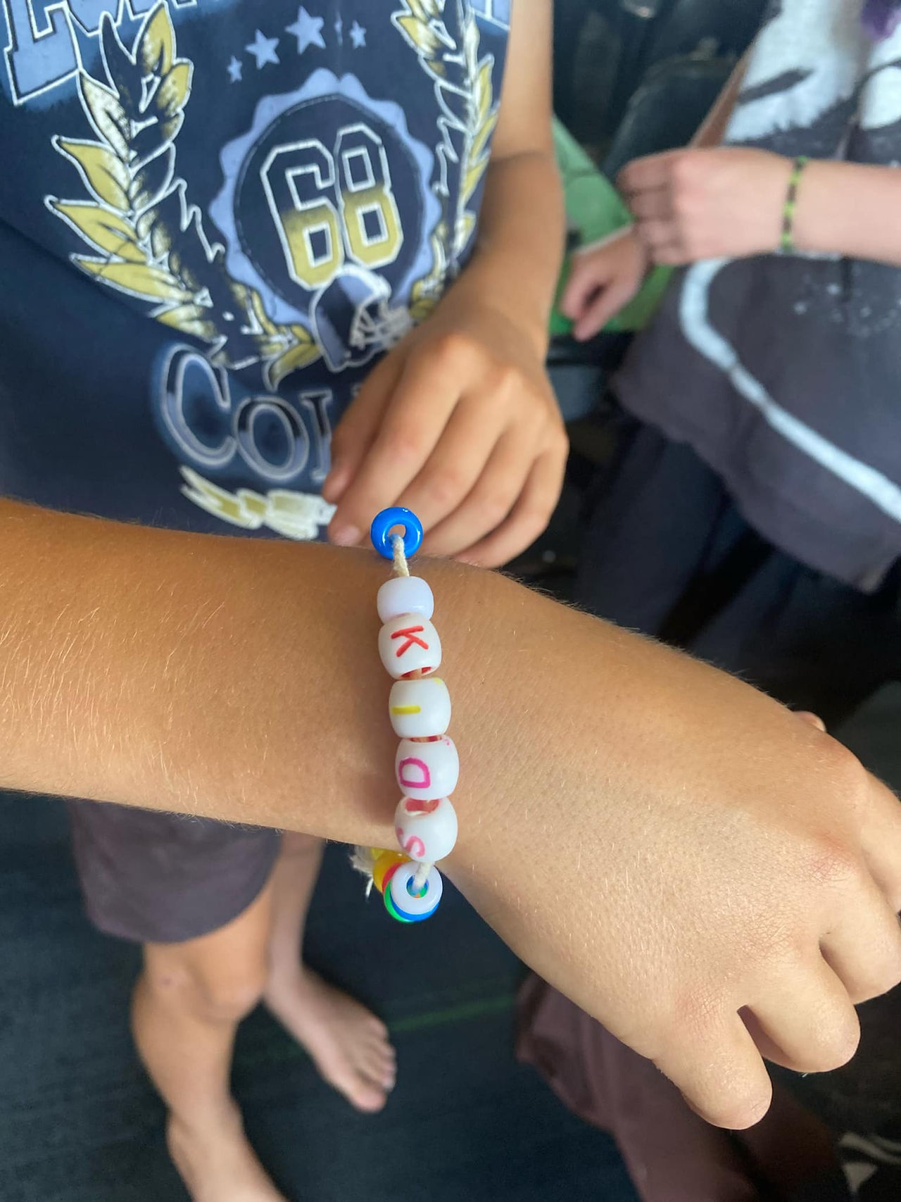 The Ōtaki Kids Market Team workshop, student shows off bracelet