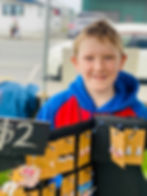 Fletcher at the Otaki Kids Market selling cat and dog earrings