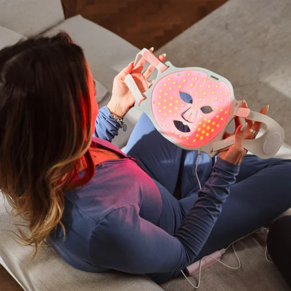 Person using red light mask