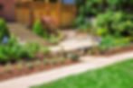 backyard hardscape with flower gardens