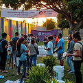 A cinematic community scene in Pomona showing diverse youth and volunteers painting a publ