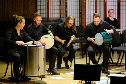 Percussionists play Brazilian pagode instruments in concert