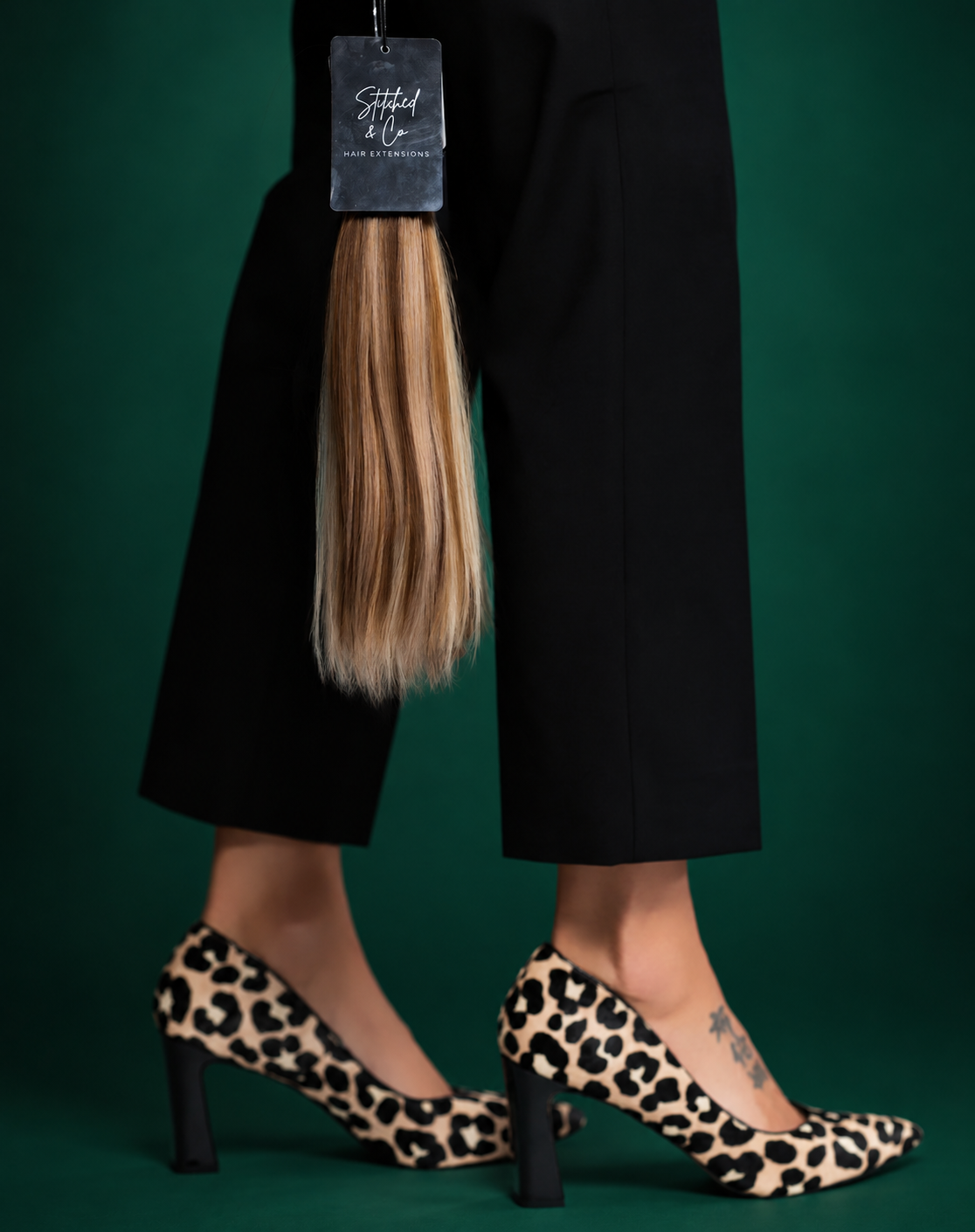 Stitched & Co extension sample with its branded tag and leopard print heels