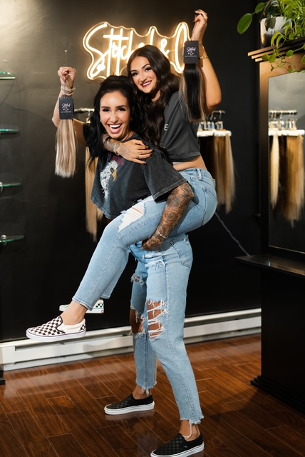 Bri and Gia sharing a playful moment in the salon