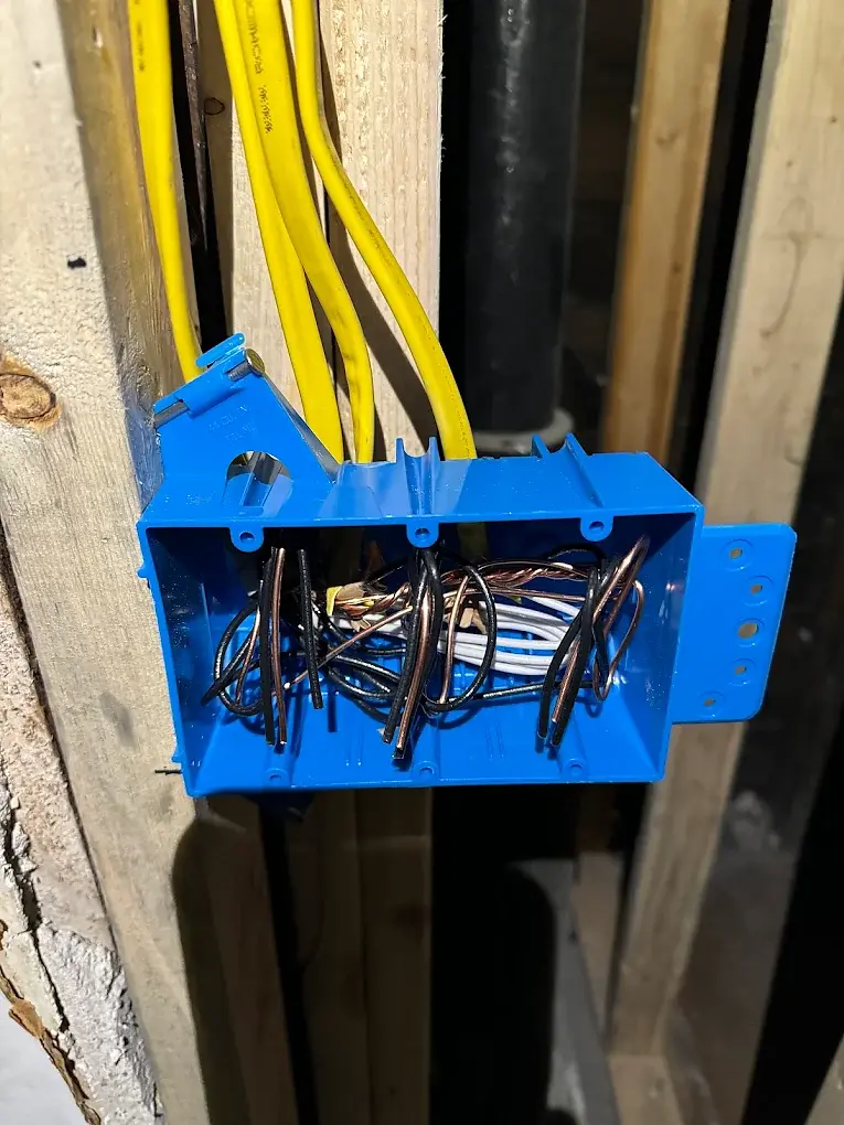 Open electrical box with wires and yellow cables