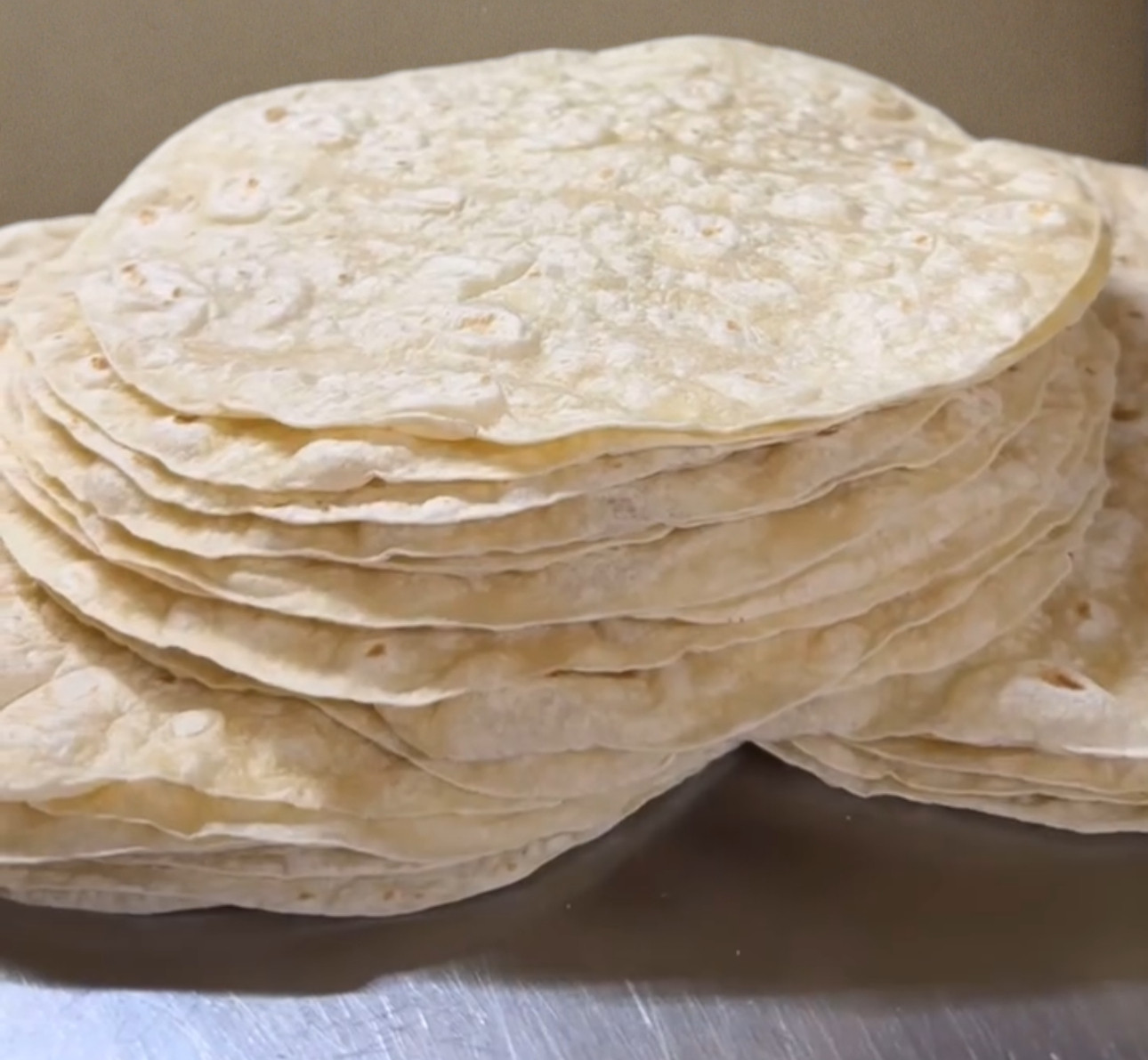 Stacked 12 inch diameter machine press tortillas for burritos