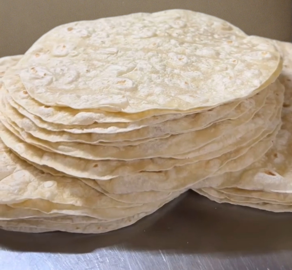 Stacked 12 inch diameter machine press tortillas for burritos