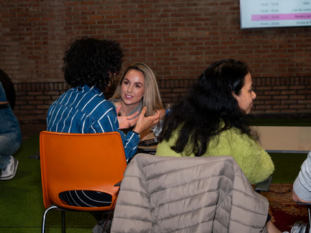A facilitator listening to an audience member talk