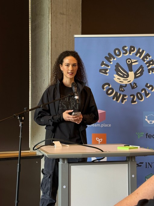 a photo of Bluesky CEO Jay Graber giving a speech at Atmosphere conference in seattle