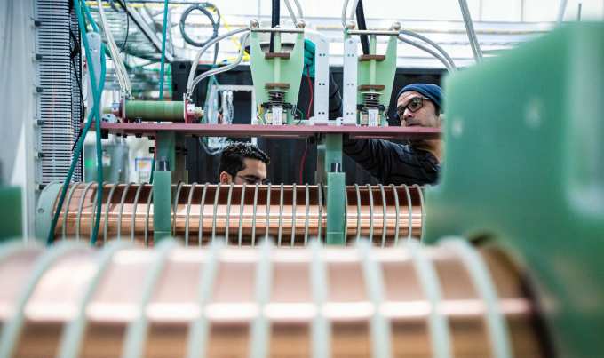 Workers inspect capacitors on Century.