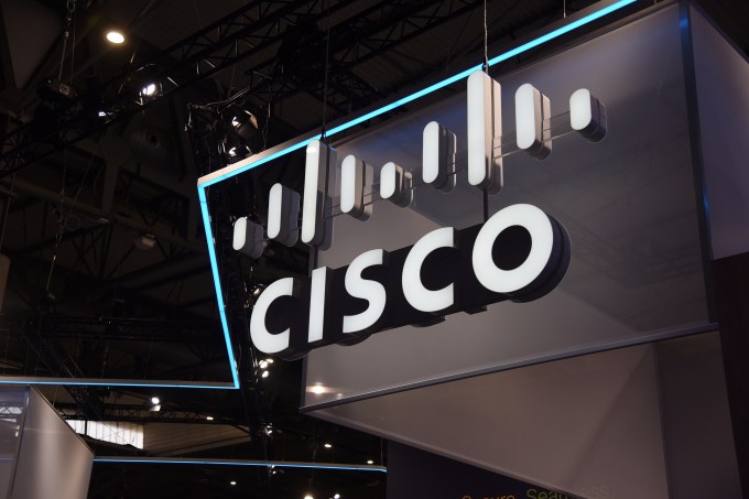 a stock image of a Cisco logo and sign from the ceiling of a convention center