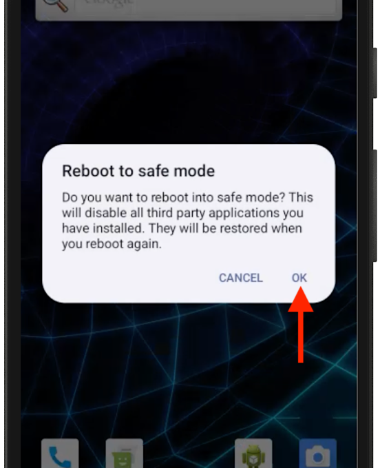 An Android screenshot with a dialog box that reads, "reboot to safe mode," followed by the text: "Do you want to reboot into safe mode? This will disable all third party applications you have installed. They will be restored when you reboot again." there is a red arrow over the "OK" button.