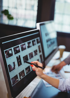 female-photo-editor-discussing-over-computer-with-2025-04-04-14-24-30-utc.jpg