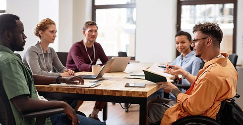 Team working at table but not looking fully engaged
