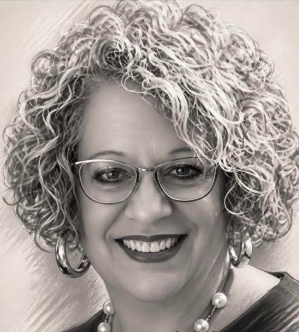 Smiling owner with curly hair and glasses