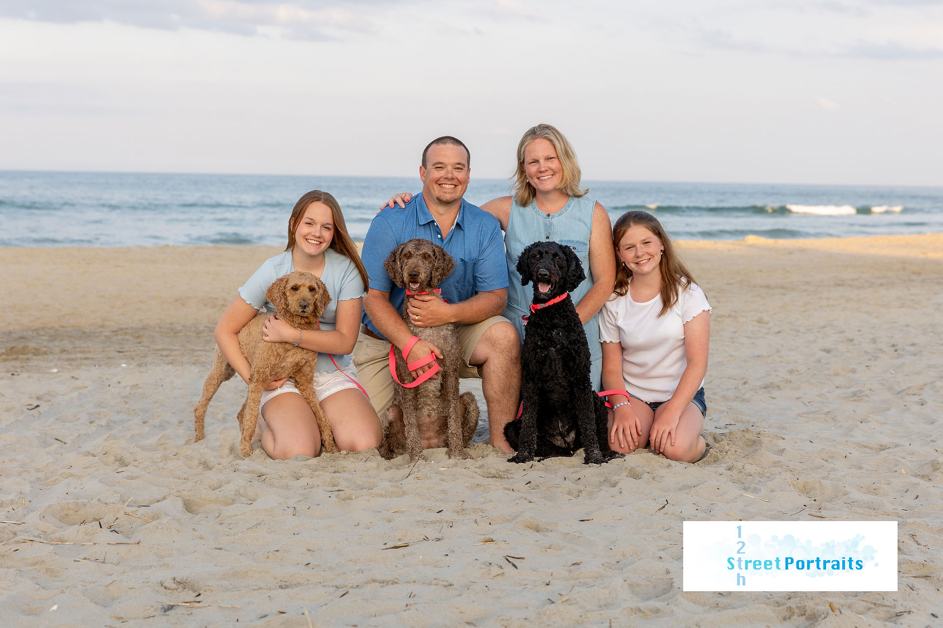 A family posing on the beach for a photo