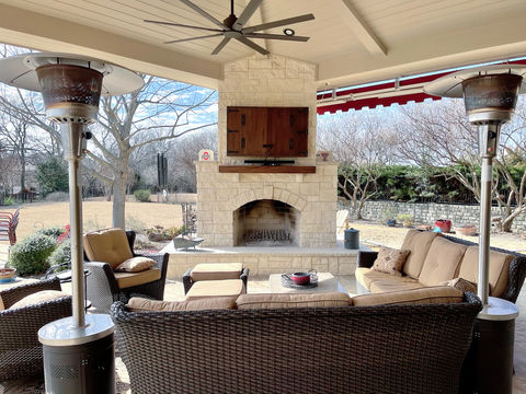 Stone fireplace and seating area in outdoor patio renovation by FERCO Construction & Remodeling in McKinney, Texas