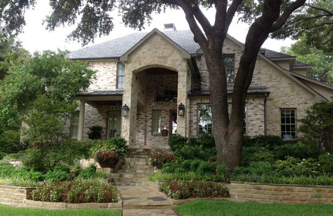 Stone exterior of a newly constructed home with a welcoming entryway by FERCO Construction & Remodeling in Dallas, Texas
