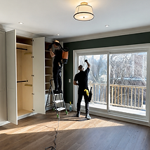 Cleaners wiping windows and closets after construction