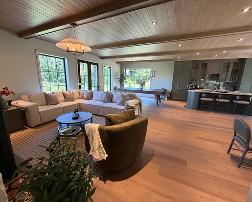 Open-concept living room with a sectional sofa and kitchen after a residential cleaning in Burlington