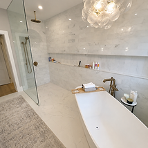 Marble bathroom with a freestanding tub after a deep clean