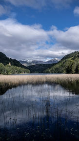 Wooden terrace with lake and mountain views at The Lake House in Futaleufú.