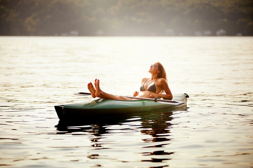 Image: Woman relaxing on a kayak in a bikini, floating on Table Rock Lake in Branson MO 