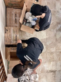 Two professional organizers in Arcadia, Az expertly unpacking moving boxes.