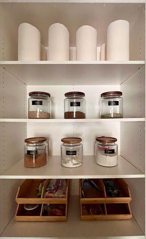 Close-up of organized pantry shelf with labeled jars and bins by Professional Organizing Plus in Phoenix, AZ