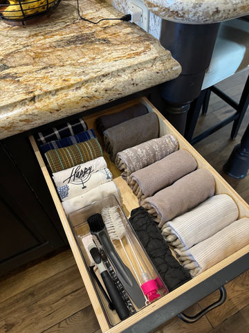 Perfectly organized kitchen drawer with file-folded dishcloths, showcasing a functional and clutter-free design by professional organizers in Arcadia, AZ