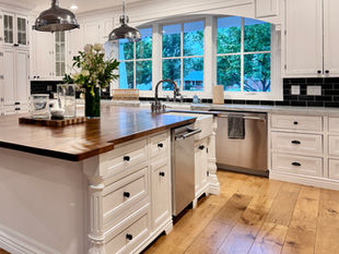 Clean white kitchen with wood floors after professional home organization in Phoenix