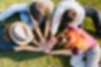 group-adult-friends-putting-hands-together