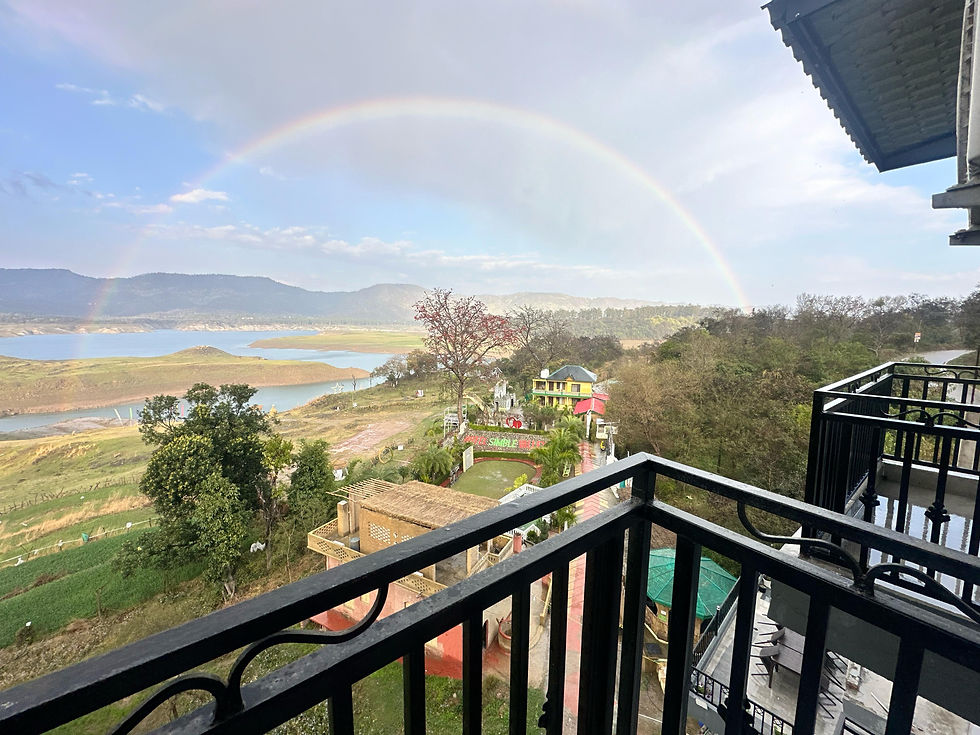 Eye-level view of hotel balcony overlooking lush green valley