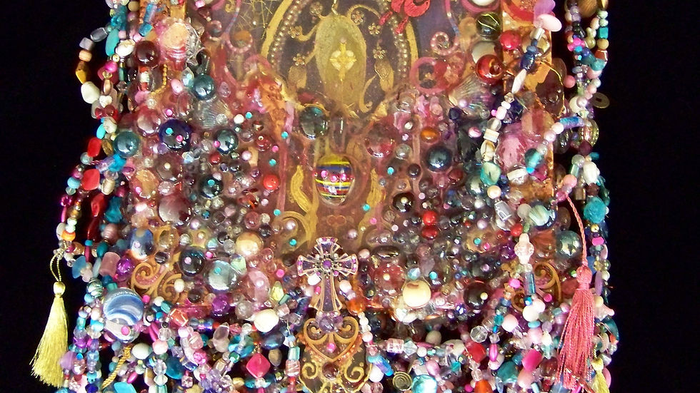 artwork featuring depiction of womb and creation with lots of beads
