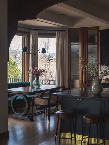 Golden, Colorado dining nook with wall sconces and full-length curtains beside kitchen.