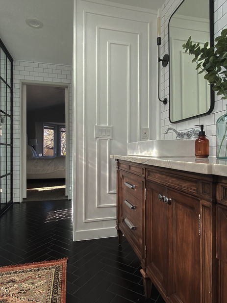 Close-up of vanity and rug leading to a bedroom in a Golden, Colorado bathroom.